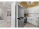 Modern kitchen with stainless steel refrigerator, updated cabinets, and stylish finishes at 3806 Gulf Of Mexico Dr # C311, Longboat Key, FL 34228