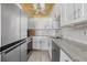 Updated kitchen with stainless steel appliances, marble countertops and tile backsplash at 3806 Gulf Of Mexico Dr # C311, Longboat Key, FL 34228