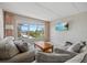 Inviting living room with large window offering beautiful ocean views, comfortable seating, and a mounted television at 3806 Gulf Of Mexico Dr # C311, Longboat Key, FL 34228