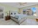 Comfortable main bedroom with two windows, tile floors, ceiling fan, and a glimpse into the living area at 3806 Gulf Of Mexico Dr # C311, Longboat Key, FL 34228