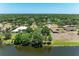 An aerial view of the home on a large lot with lake access and mature trees at 410 136Th E Ct, Bradenton, FL 34212