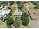 An aerial view of the home with an enclosed pool and mature trees at 410 136Th E Ct, Bradenton, FL 34212