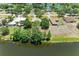 An aerial view of the home on a large lot with lake access and mature trees at 410 136Th E Ct, Bradenton, FL 34212