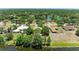 Beautiful aerial view of homes near a serene lake surrounded by lush trees under a clear blue sky at 410 136Th E Ct, Bradenton, FL 34212