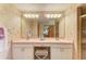 Bathroom featuring dual sinks, vanity, and a large mirror at 410 136Th E Ct, Bradenton, FL 34212