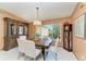 Traditional dining room features a wood table, chandelier, and large china cabinet for elegant Gathering gatherings at 410 136Th E Ct, Bradenton, FL 34212