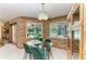 Cozy dining area with view to the pool, stone fireplace, and space for memorable meals at 410 136Th E Ct, Bradenton, FL 34212