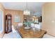 Light-filled dining room with chandelier and wood table for cozy dining and elegant entertaining at 410 136Th E Ct, Bradenton, FL 34212