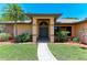 Inviting home entryway showcasing a landscaped yard with colorful plants leading to the covered front door at 410 136Th E Ct, Bradenton, FL 34212