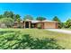 Charming single-story home featuring a well-manicured lawn, mature trees, and an attached two-car garage at 410 136Th E Ct, Bradenton, FL 34212