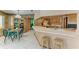 Eat-in kitchen with breakfast bar and green glass table and chairs for everyday dining at 410 136Th E Ct, Bradenton, FL 34212