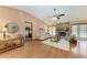 Cozy living room with hardwood floors, a stone fireplace, and French doors leading to the outdoor space at 410 136Th E Ct, Bradenton, FL 34212