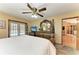 Spacious main bedroom boasts French doors to the pool and a decorative wood dresser with a large mirror at 410 136Th E Ct, Bradenton, FL 34212