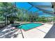 Sparkling in-ground pool and jacuzzi surrounded by a screened enclosure and manicured landscaping at 410 136Th E Ct, Bradenton, FL 34212
