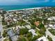 An aerial view shows a residential area near the beach with views of the city skyline and ocean at 410 Garfield Dr, Sarasota, FL 34236