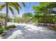 Spacious backyard featuring beachy sand, tropical plants and comfortable seating at 410 Garfield Dr, Sarasota, FL 34236