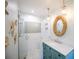 Stylish renovated bathroom featuring a glass shower and a blue vanity at 410 Garfield Dr, Sarasota, FL 34236