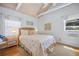 Bright bedroom with a vaulted ceiling, window and comfortable starfish themed bedding at 410 Garfield Dr, Sarasota, FL 34236