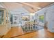 Well-lit dining room with wood floors, vaulted ceilings, and an elegant chandelier at 410 Garfield Dr, Sarasota, FL 34236