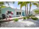 Charming single-story home with a welcoming porch and tropical landscaping at 410 Garfield Dr, Sarasota, FL 34236