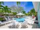 Beautiful pool area surrounded by lush landscaping and lounge seating at 410 Garfield Dr, Sarasota, FL 34236