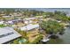 Waterfront home with boat dock featuring screened-in porch and well-maintained landscaping at 4309 Pinfish Ln, Palmetto, FL 34221