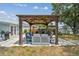 Backyard patio with stylish seating area, hot tub, and barbecue for outdoor entertaining at 4309 Pinfish Ln, Palmetto, FL 34221