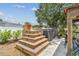 Outdoor hot tub with wooden steps and modern design, nestled in a serene backyard setting at 4309 Pinfish Ln, Palmetto, FL 34221