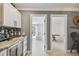 Bright wet bar with marble countertops, wine fridge, and views to other rooms at 4309 Pinfish Ln, Palmetto, FL 34221