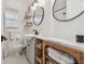 Cozy bathroom featuring wood accents, modern fixtures, and unique vanity arrangement with shelving at 4309 Pinfish Ln, Palmetto, FL 34221