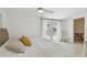 Bright bedroom with white linens, French doors and a ceiling fan at 4309 Pinfish Ln, Palmetto, FL 34221