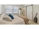 Cozy bedroom with a barn door, light wood floors, large window, and ample space for storage at 4309 Pinfish Ln, Palmetto, FL 34221