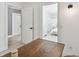 View from office to bedroom with white furnishings and hardwood floors at 4309 Pinfish Ln, Palmetto, FL 34221