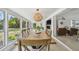 Dining room with backyard views, open floor plan, and stylish pendant lighting at 4309 Pinfish Ln, Palmetto, FL 34221