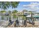 Private wooden dock with Adirondack chairs, providing waterfront views and boat access at 4309 Pinfish Ln, Palmetto, FL 34221