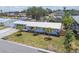 Charming single-story home with well-maintained landscaping, palm trees, and a silver metal roof at 4309 Pinfish Ln, Palmetto, FL 34221