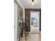 Hallway with brick accent wall leading to a living area with a mounted TV at 4309 Pinfish Ln, Palmetto, FL 34221
