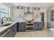 Modern kitchen featuring stainless steel appliances, stylish cabinets, and herringbone backsplash at 4309 Pinfish Ln, Palmetto, FL 34221