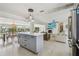Open-concept kitchen featuring an island with quartz countertops, seamlessly connecting the living spaces at 4309 Pinfish Ln, Palmetto, FL 34221
