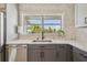 Bright kitchen with stainless steel appliances, quartz countertops, and a view of lush landscaping at 4309 Pinfish Ln, Palmetto, FL 34221