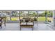 Sunroom with large windows offering views of the backyard, comfortable seating, and bright natural light at 4309 Pinfish Ln, Palmetto, FL 34221