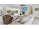 Spacious living room with a fireplace, large sectional sofa, and hardwood floors perfect for relaxing at 4309 Pinfish Ln, Palmetto, FL 34221