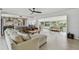Open-concept living space featuring a modern kitchen, hardwood floors, and an abundance of natural light at 4309 Pinfish Ln, Palmetto, FL 34221