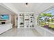 Bright, stylish living area featuring hardwood floors, a large window, and custom built-in shelving with decor at 4309 Pinfish Ln, Palmetto, FL 34221