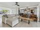 Open-concept living space featuring a modern kitchen, hardwood floors, and an abundance of natural light at 4309 Pinfish Ln, Palmetto, FL 34221
