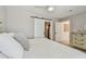 Spacious main bedroom featuring a barn door to the ensuite bathroom and a dresser with stylish decor at 4309 Pinfish Ln, Palmetto, FL 34221