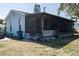 Exterior view of the home with a screened-in porch and grassy yard at 4403 5Th W Ave, Palmetto, FL 34221