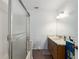 Bathroom featuring a shower with glass door, vanity with marble countertop, and wood flooring at 4403 5Th W Ave, Palmetto, FL 34221