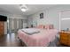 Spacious main bedroom featuring a ceiling fan, sliding glass door, and wood flooring at 4403 5Th W Ave, Palmetto, FL 34221