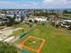 This aerial view shows a community baseball field, green spaces, and recreational opportunities in a beautiful setting at 501 Key Royale Dr, Holmes Beach, FL 34217